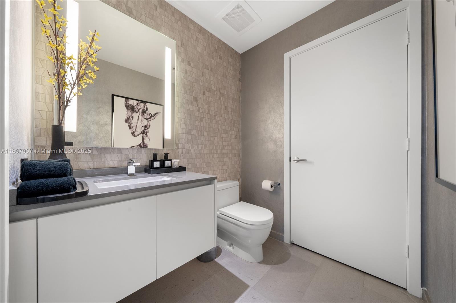 88 Southwest 7th Street, Unit 3910 Miami, FL 33130 - Photo 16 of 38 a bathroom with a toilet a sink and mirror