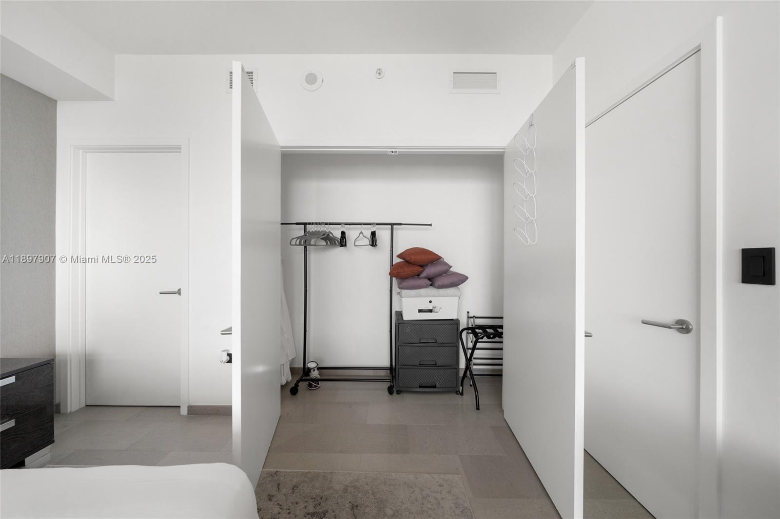 88 Southwest 7th Street, Unit 3910 Miami, FL 33130 - Photo 27 of 38 a view of walk in closet with clothes and shoes