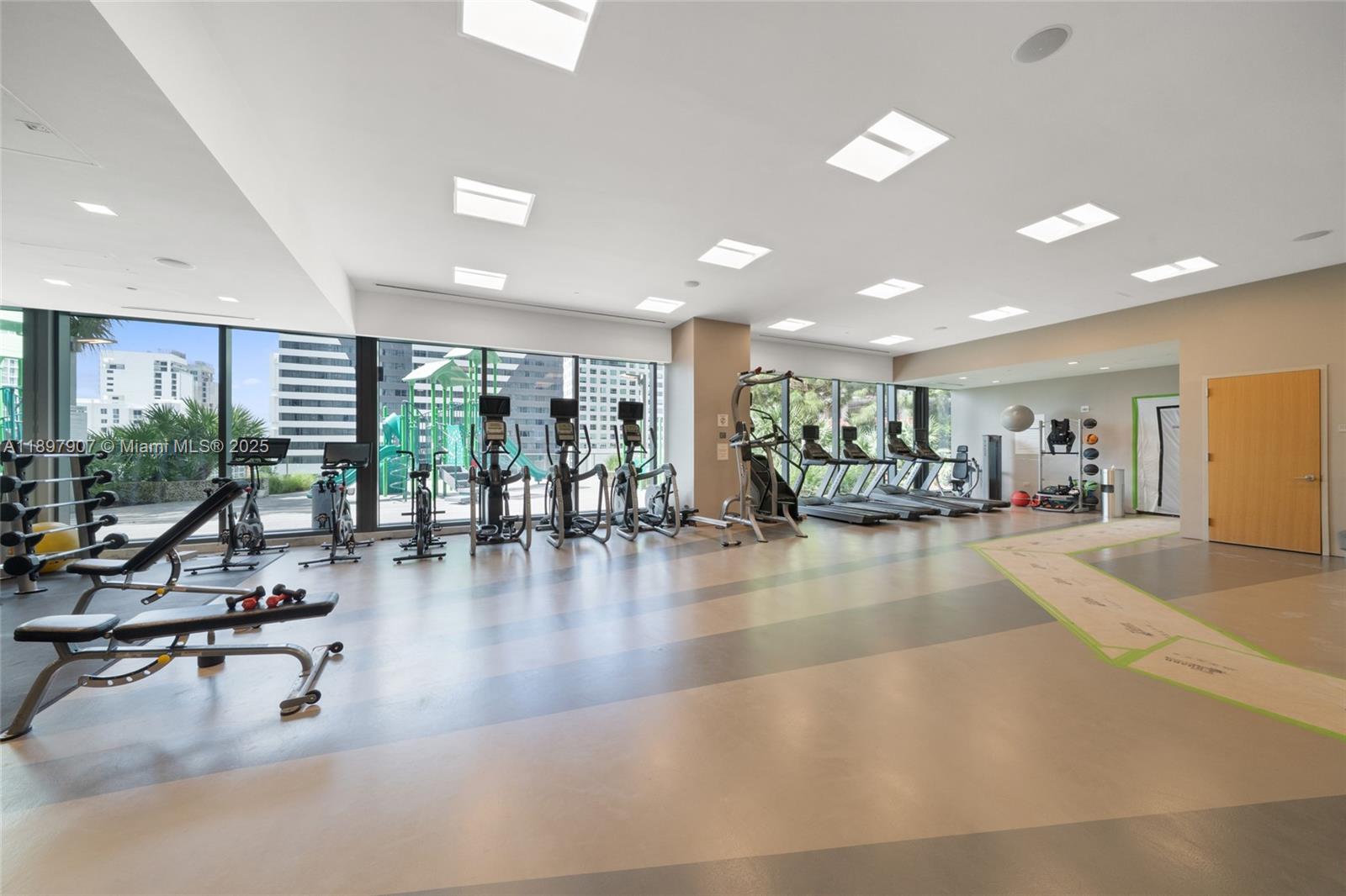 88 Southwest 7th Street, Unit 3910 Miami, FL 33130 - Photo 29 of 38 a view of a gym room with gym equipment