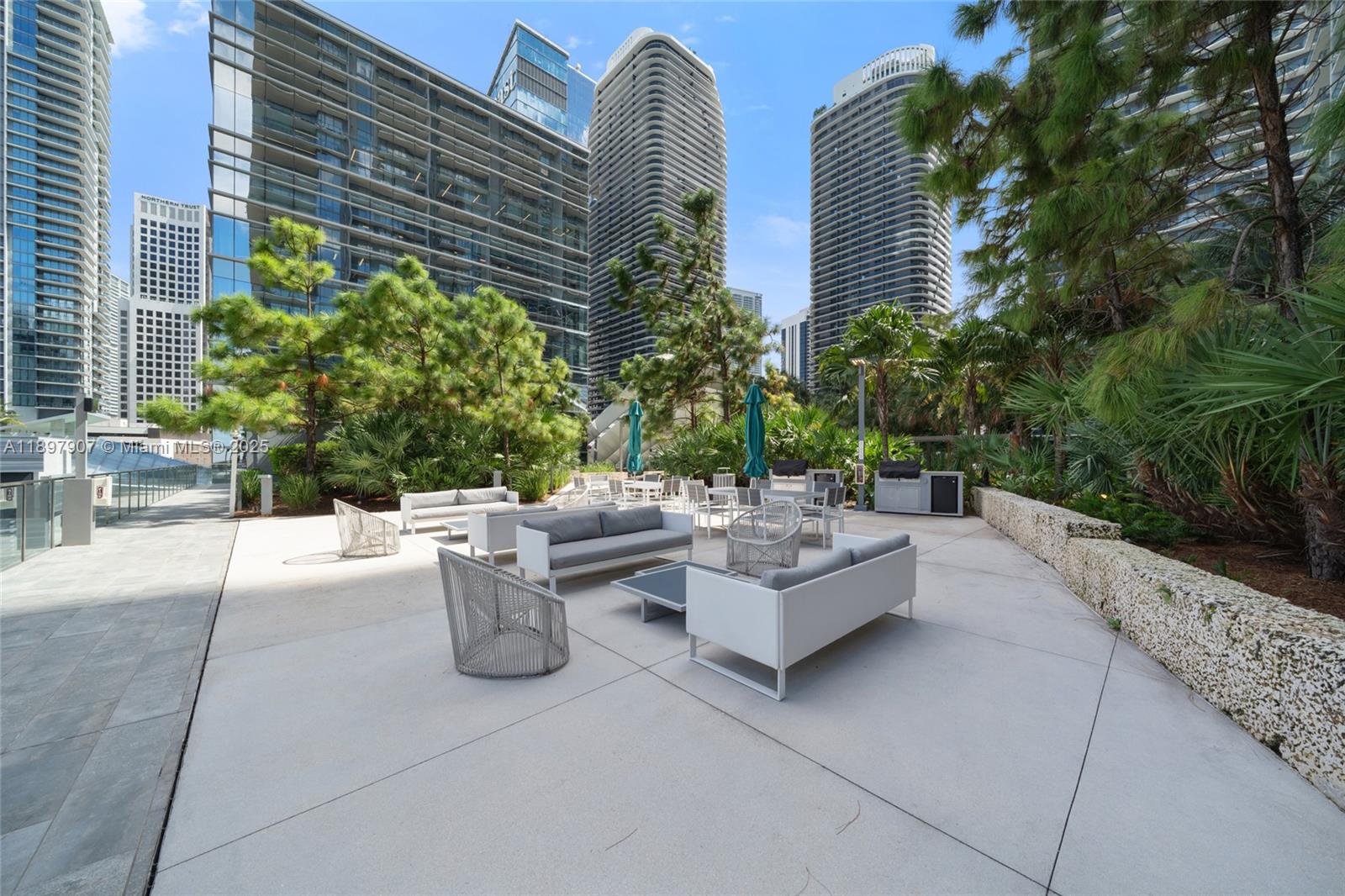 88 Southwest 7th Street, Unit 3910 Miami, FL 33130 - Photo 34 of 38 a view of backyard with outdoor seating and plants