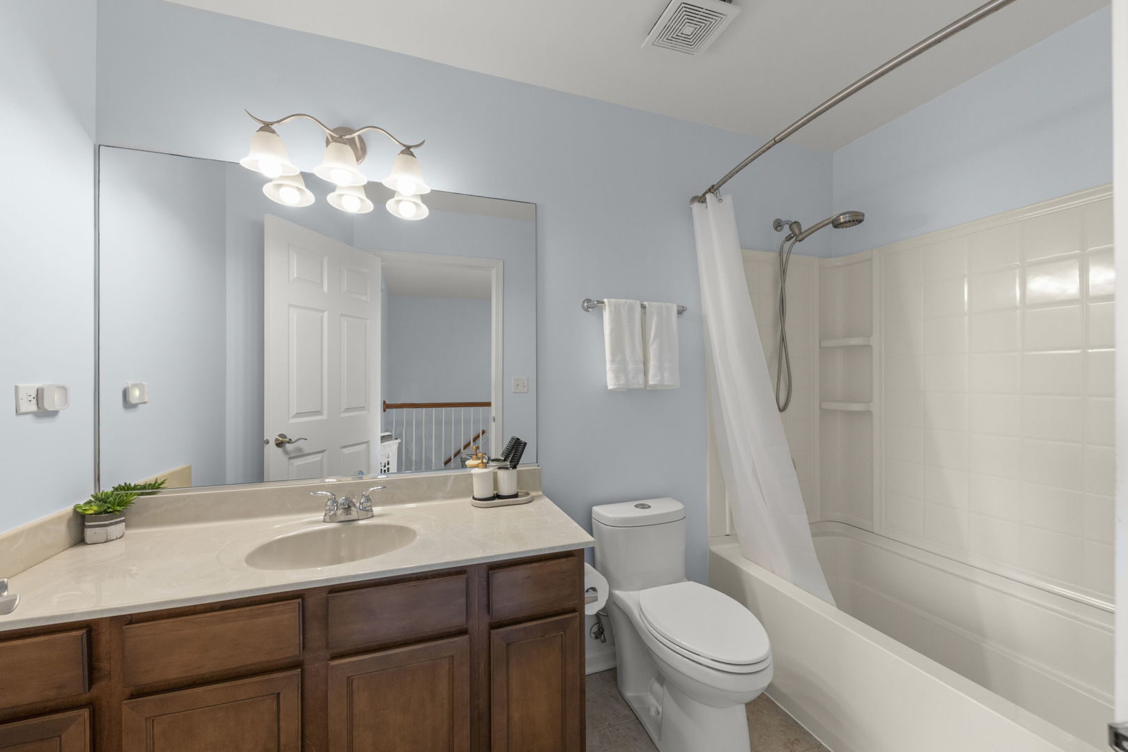341 North Commerce Street Aurora, IL 60504 - Photo 17 of 26 a bathroom with a sink a toilet a mirror and shower