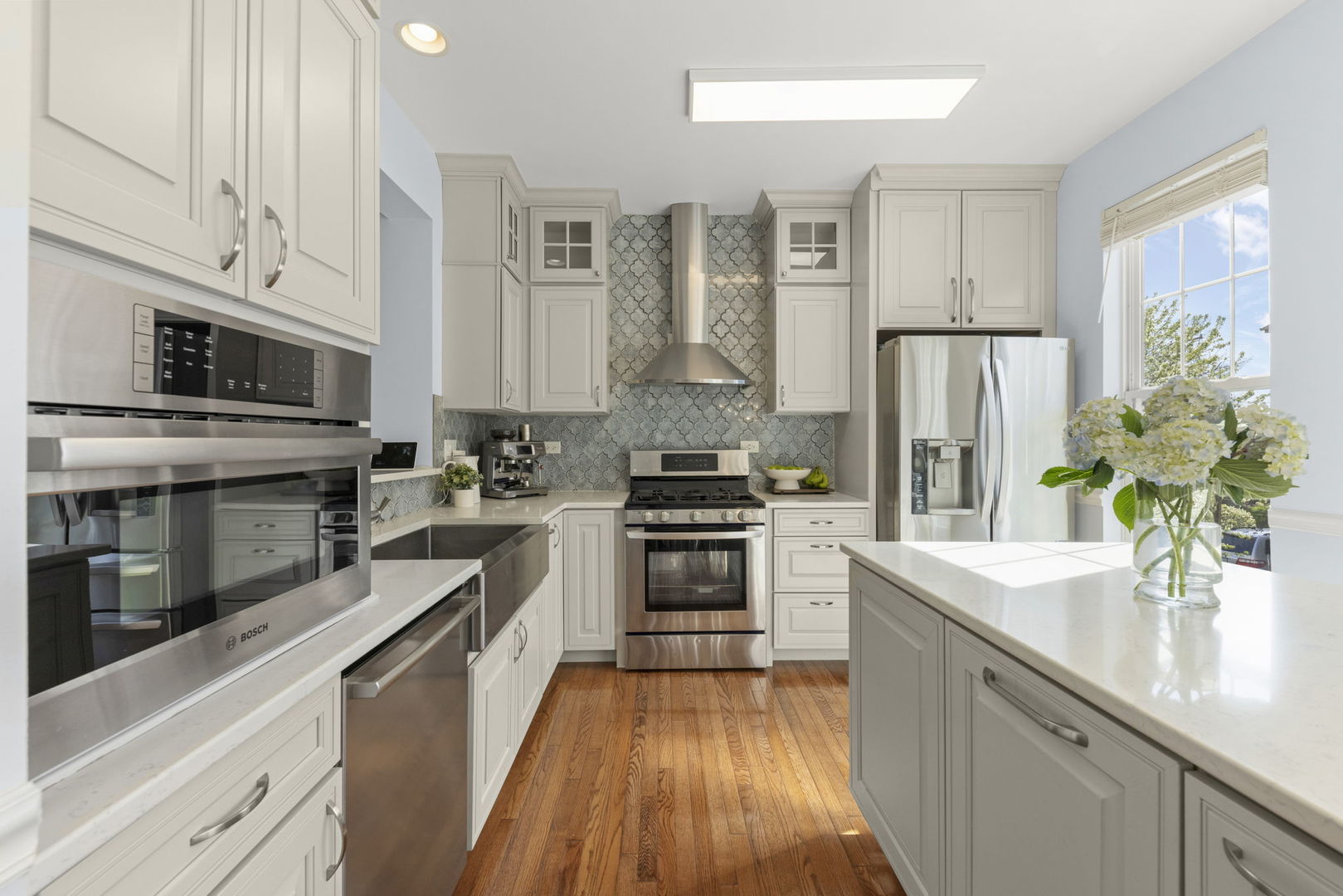 341 North Commerce Street Aurora, IL 60504 - Photo 2 of 26 a kitchen with stainless steel appliances a sink dishwasher a refrigerator a stove and white cabinets with wooden floor