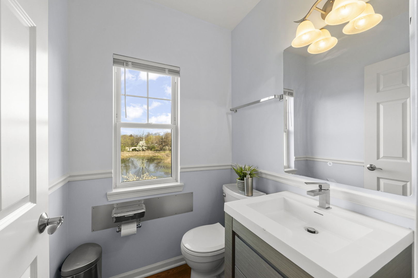 341 North Commerce Street Aurora, IL 60504 - Photo 9 of 26 a bathroom with a sink a toilet and a mirror