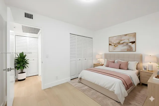 a bedroom with a balcony a bed and a potted plant