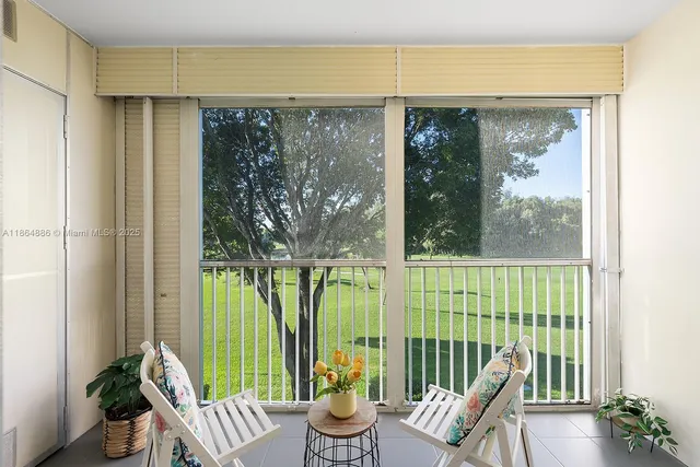 a living room with a large window and table