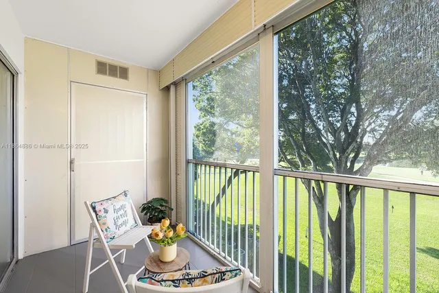 a view of a porch with furniture and wooden deck