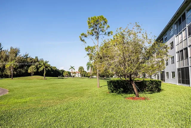 a view of a garden with a building in the background