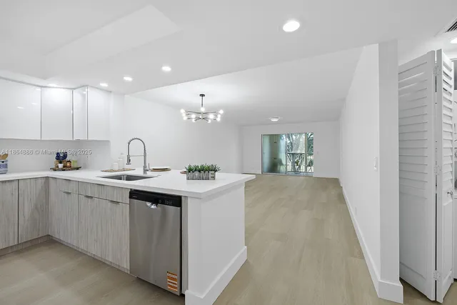 a large white kitchen with a sink
