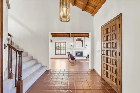 a living room with fireplace furniture and a large window