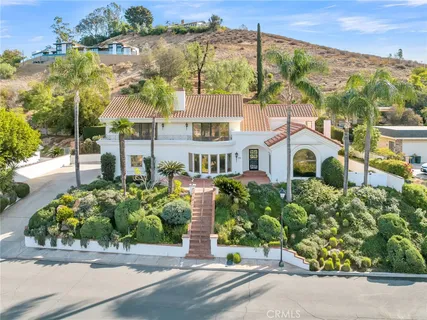 a front view of a house with a garden and pathway