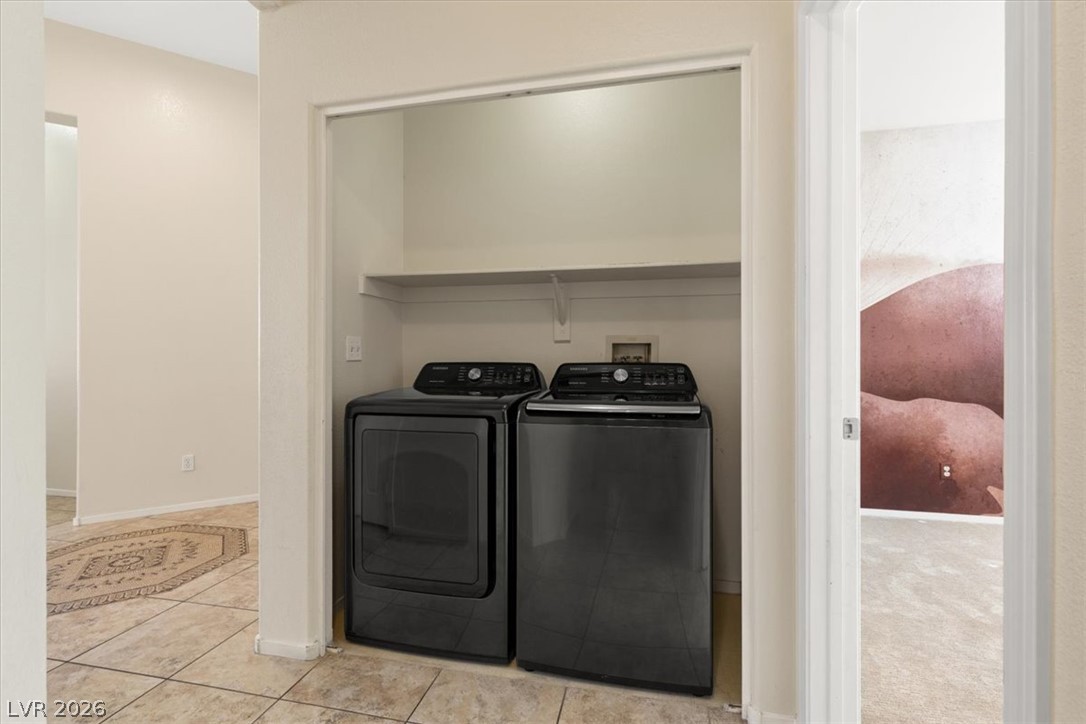 1007 Golden Ridge Court Henderson, NV 89052 - Photo 17 of 27 An organized laundry closet with overhead shelving sits adjacent to tiled flooring.