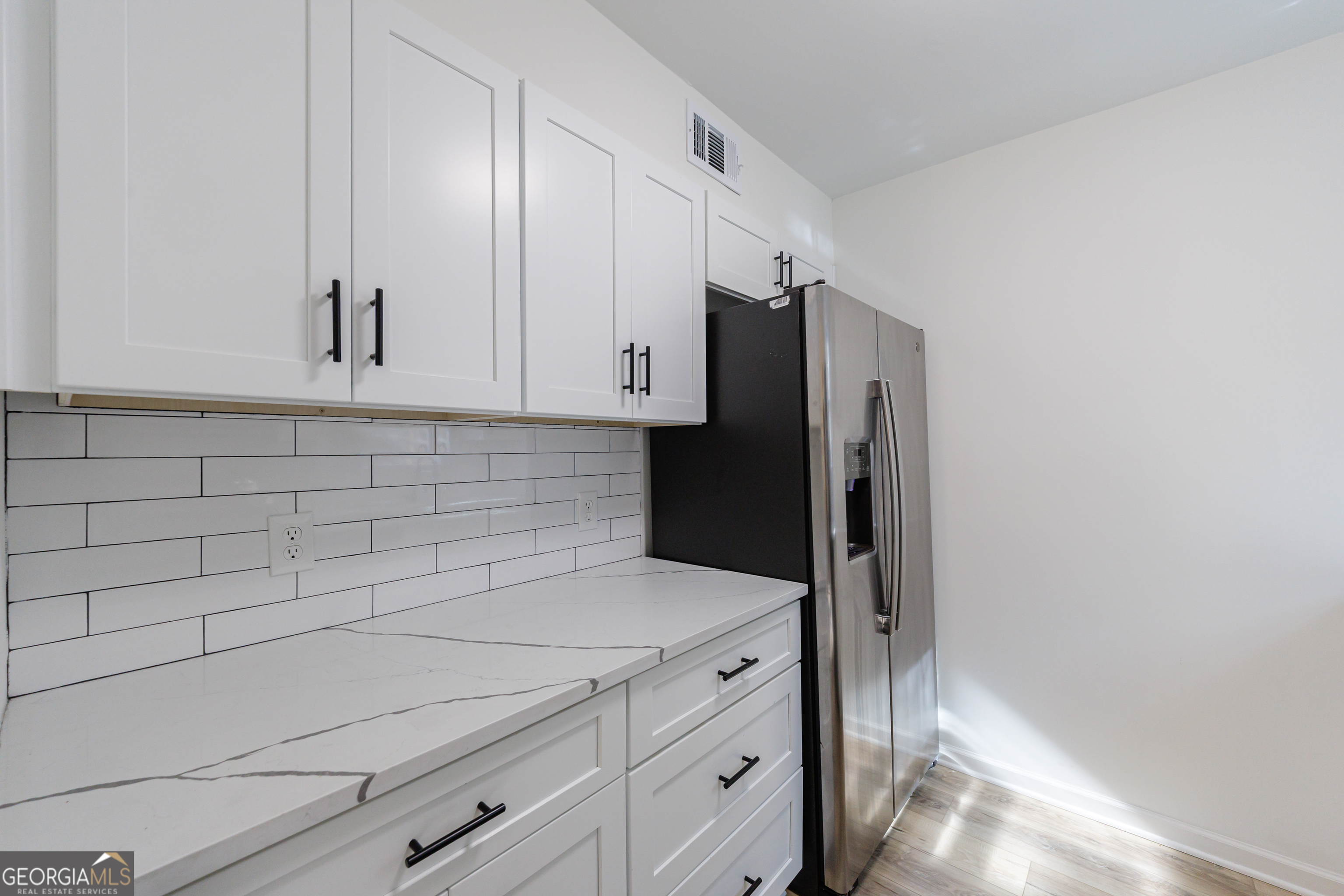 2386 Lawrenceville Highway Decatur, GA 30033 - Photo 16 of 55 a kitchen with stainless steel appliances white cabinets and a refrigerator