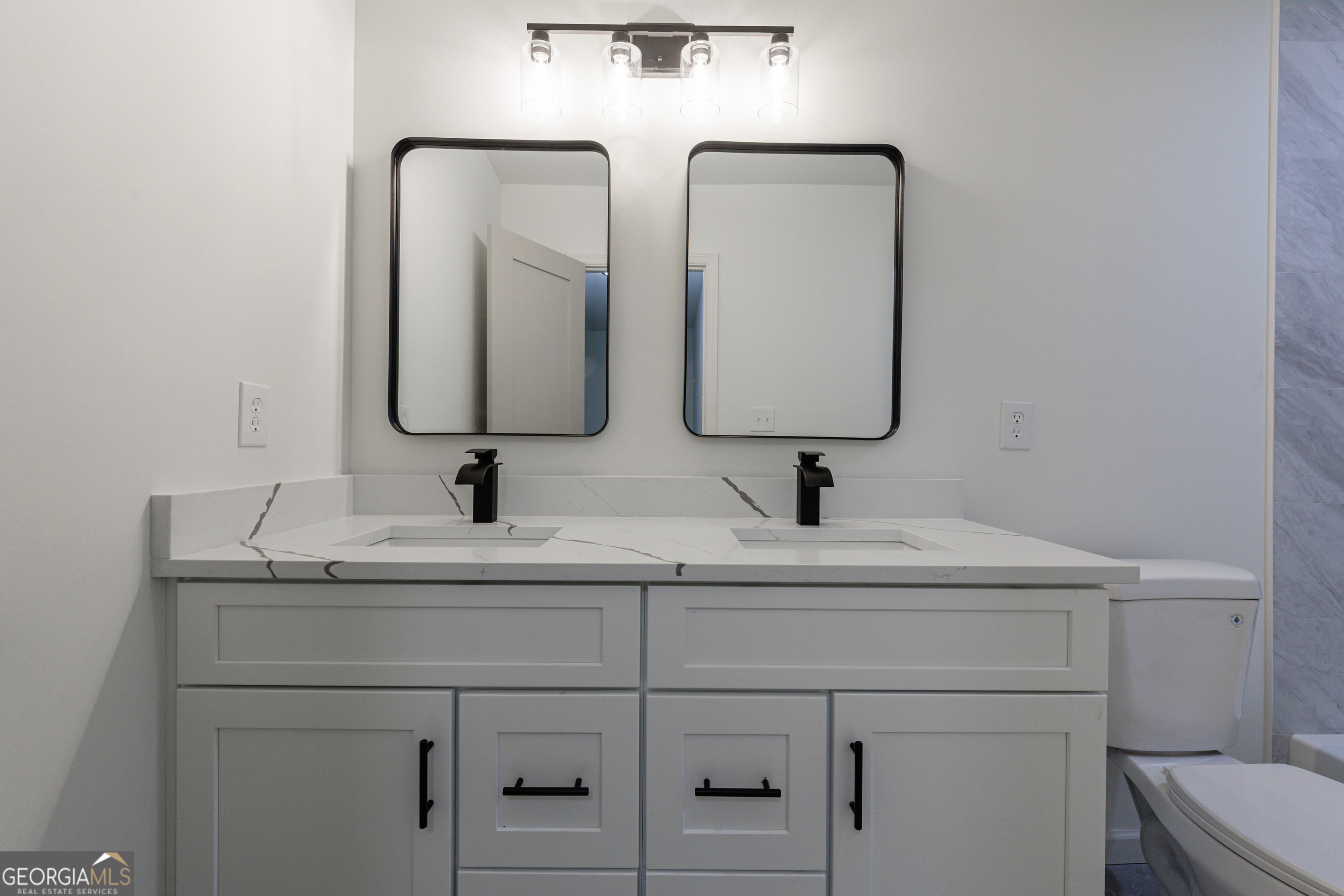2386 Lawrenceville Highway Decatur, GA 30033 - Photo 29 of 55 a bathroom with 2 sink and a mirror