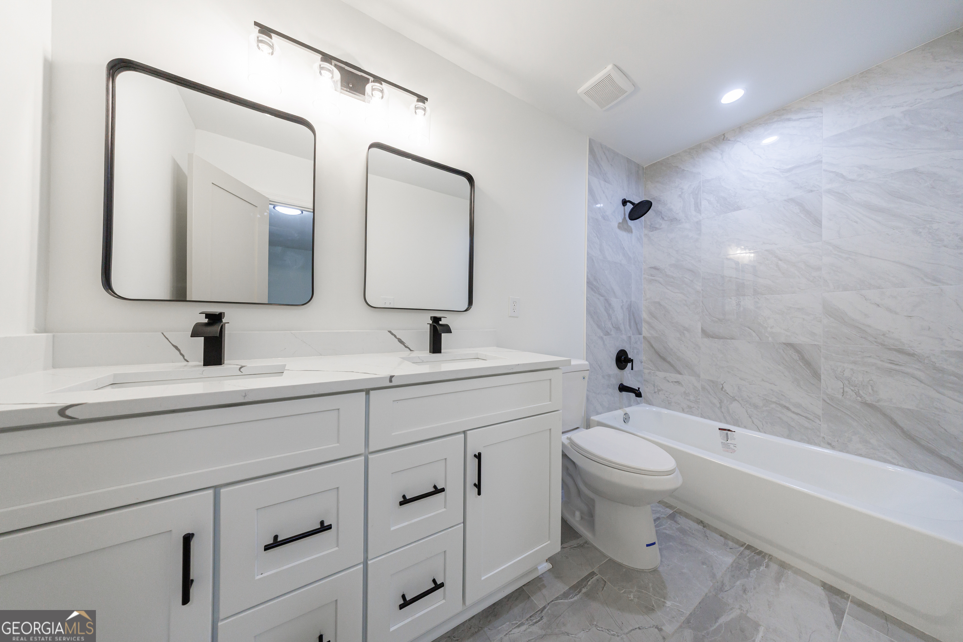 2386 Lawrenceville Highway Decatur, GA 30033 - Photo 30 of 55 a bathroom with a double vanity sink toilet mirror and bathtub