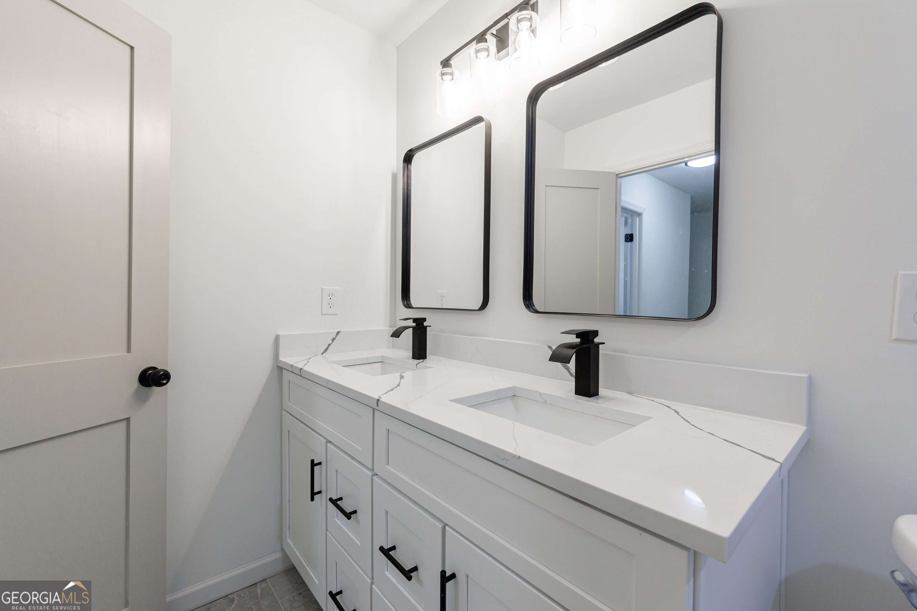 2386 Lawrenceville Highway Decatur, GA 30033 - Photo 31 of 55 a bathroom with a double vanity sink and mirror