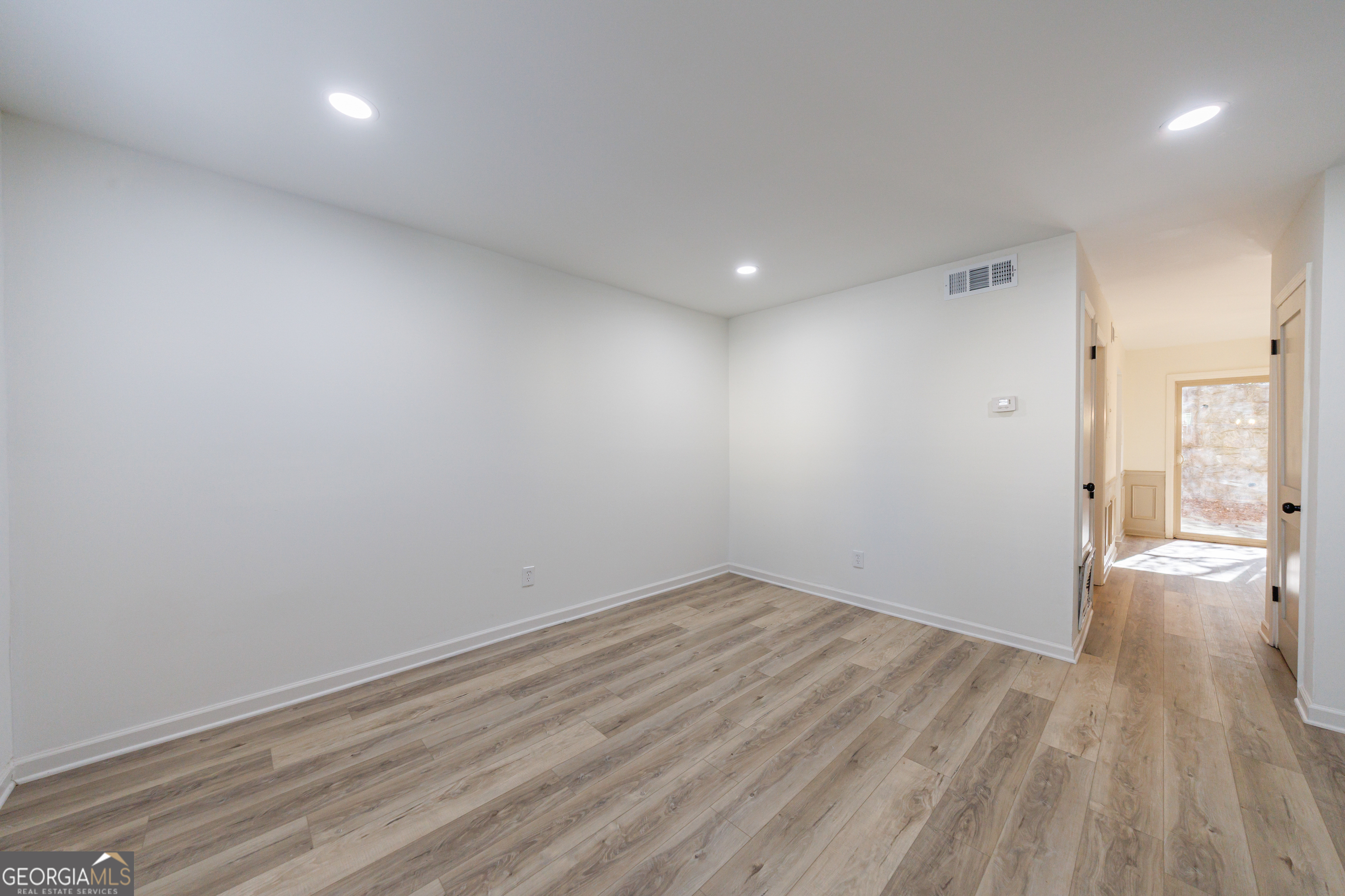 2386 Lawrenceville Highway Decatur, GA 30033 - Photo 8 of 55 an empty room with wooden floor and windows