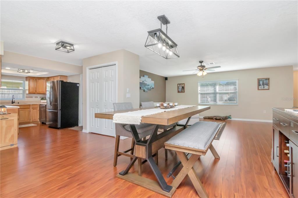9791 Horizon Drive Spring Hill, FL 34608 - Photo 11 of 38 a view of a dining room with furniture and wooden floor