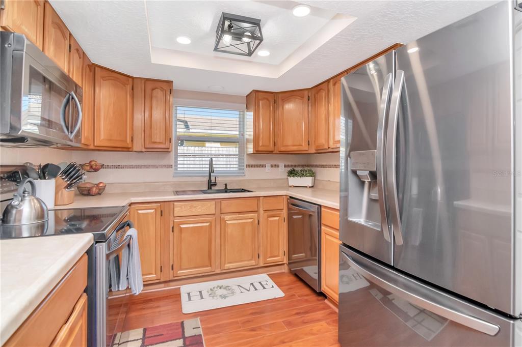 9791 Horizon Drive Spring Hill, FL 34608 - Photo 17 of 38 a kitchen with stainless steel appliances granite countertop a refrigerator sink and cabinets