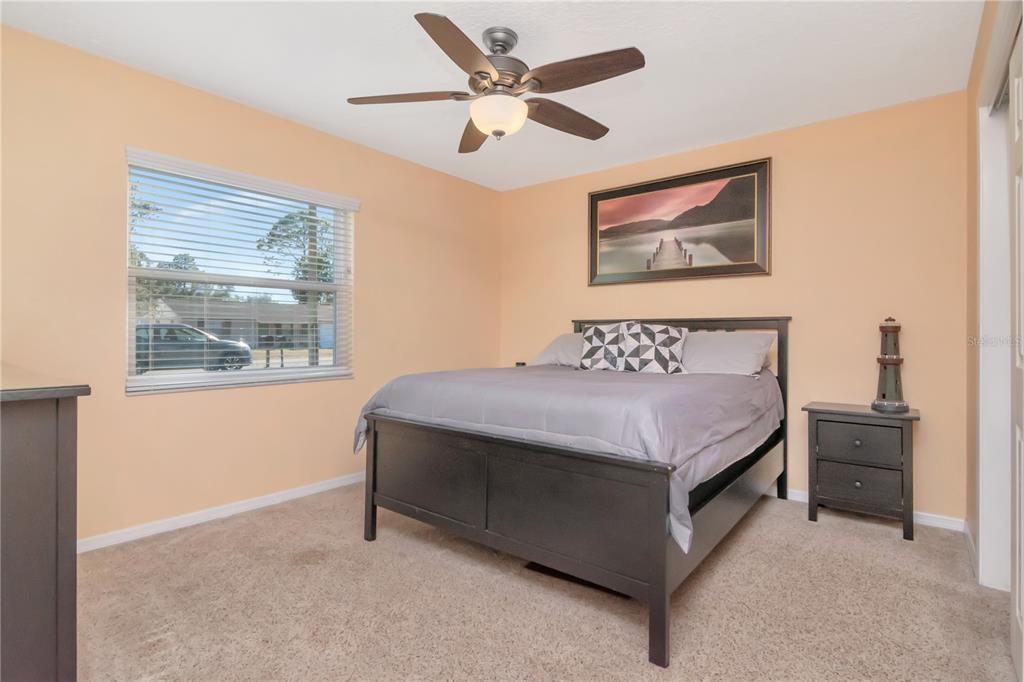 9791 Horizon Drive Spring Hill, FL 34608 - Photo 20 of 38 a bedroom with a bed and a painting on the wall