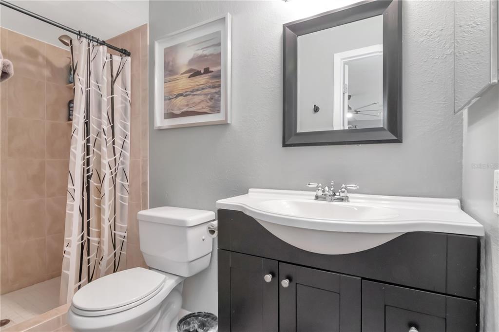 9791 Horizon Drive Spring Hill, FL 34608 - Photo 26 of 38 a bathroom with a sink vanity mirror and toilet