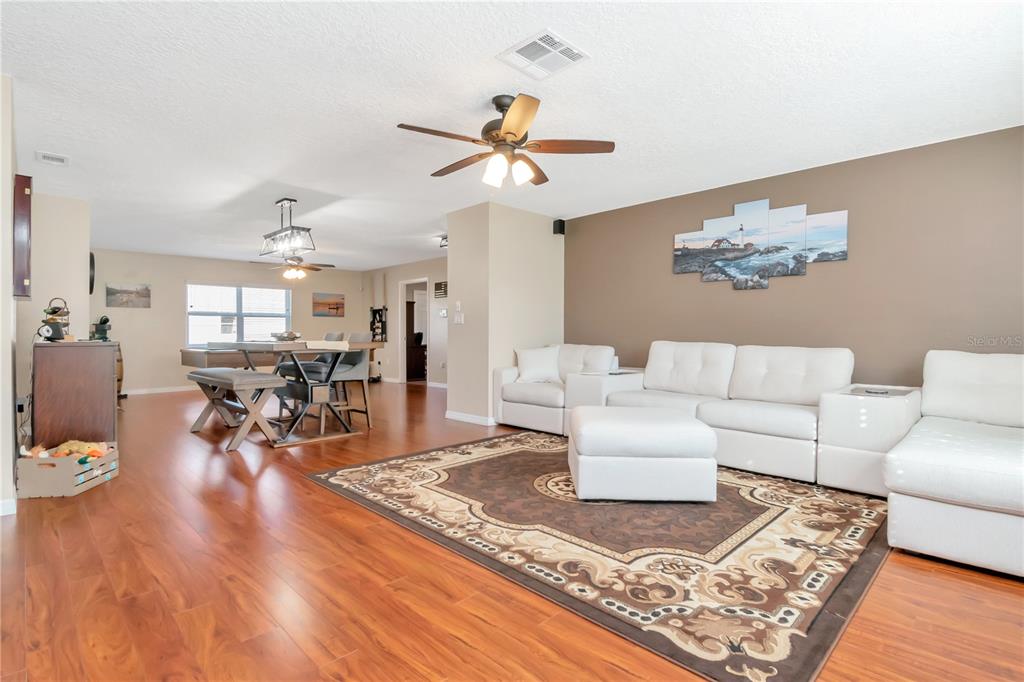 9791 Horizon Drive Spring Hill, FL 34608 - Photo 4 of 38 a living room with furniture and a wooden floor