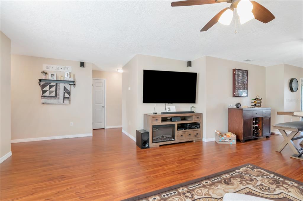 9791 Horizon Drive Spring Hill, FL 34608 - Photo 5 of 38 a living room with furniture and a flat screen tv
