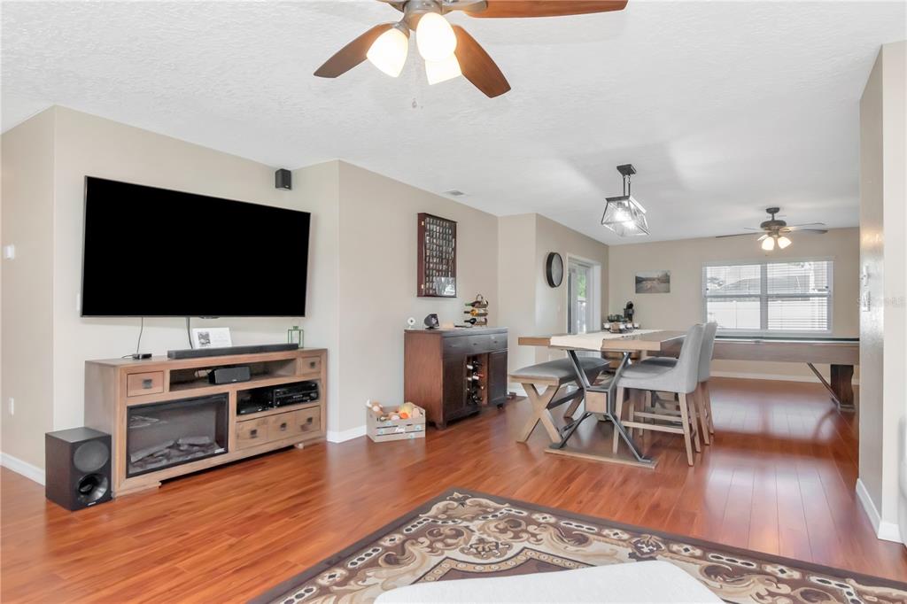 9791 Horizon Drive Spring Hill, FL 34608 - Photo 6 of 38 a living room with furniture and a flat screen tv
