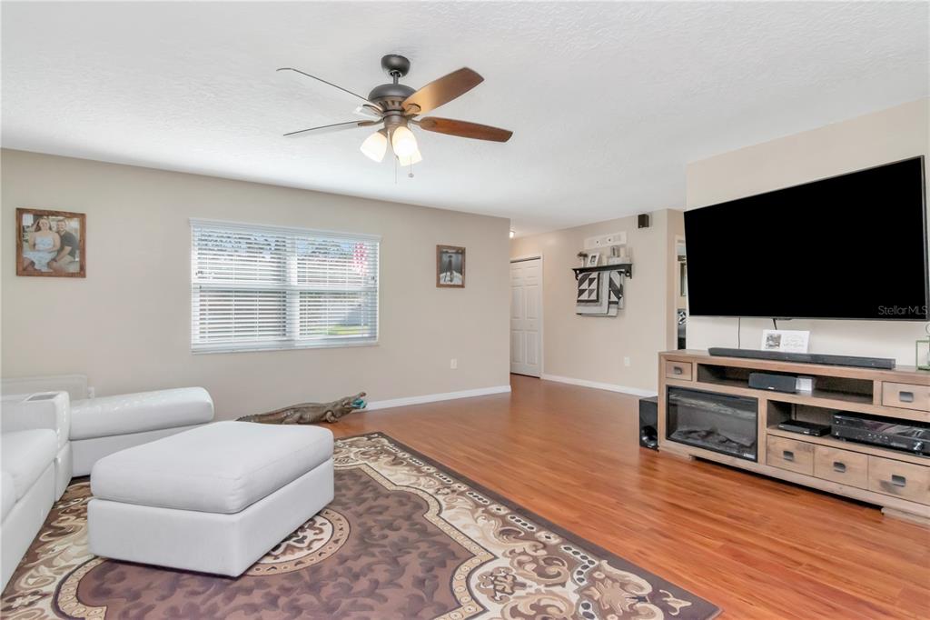 9791 Horizon Drive Spring Hill, FL 34608 - Photo 7 of 38 a living room with furniture and a flat screen tv