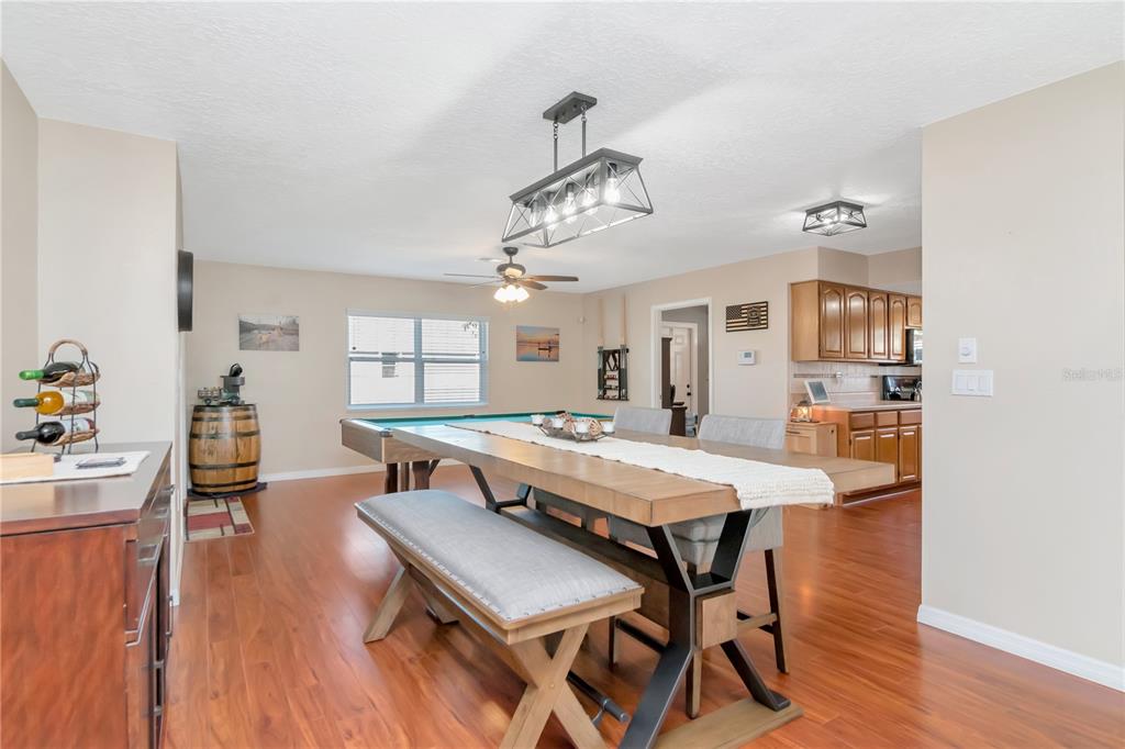 9791 Horizon Drive Spring Hill, FL 34608 - Photo 9 of 38 a view of a dining room with furniture and wooden floor