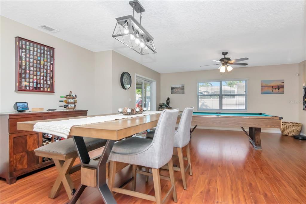 9791 Horizon Drive Spring Hill, FL 34608 - Photo 10 of 38 a view of a dining room with furniture window and wooden floor