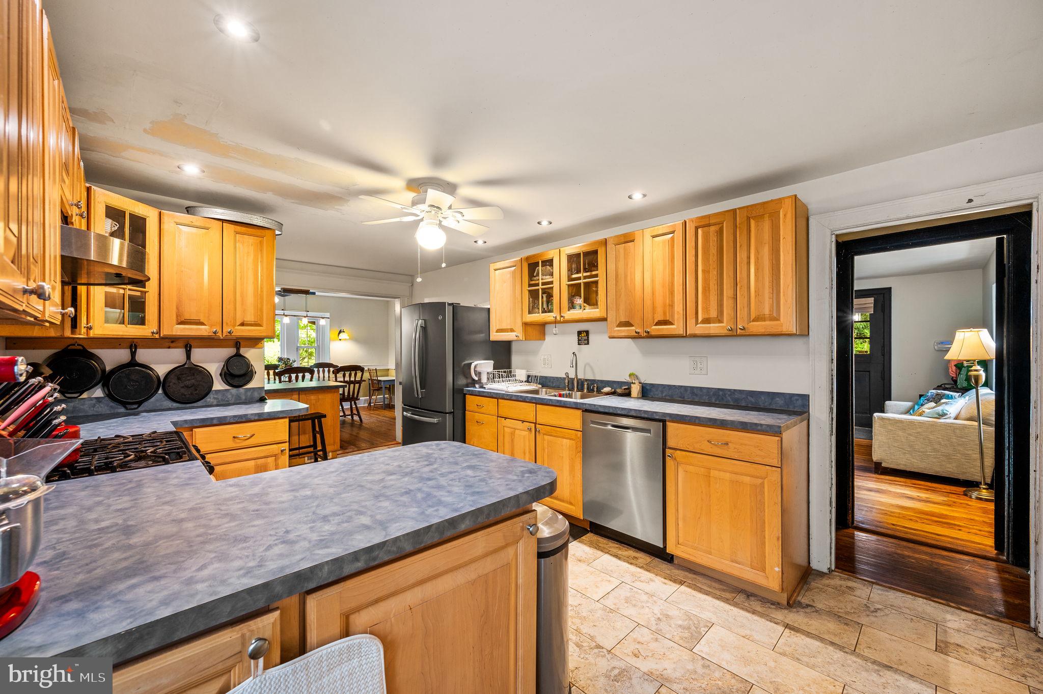 408 East Woodlawn Street Philadelphia, PA 19144 - Photo 12 of 31 a kitchen with stainless steel appliances granite countertop sink stove and refrigerator