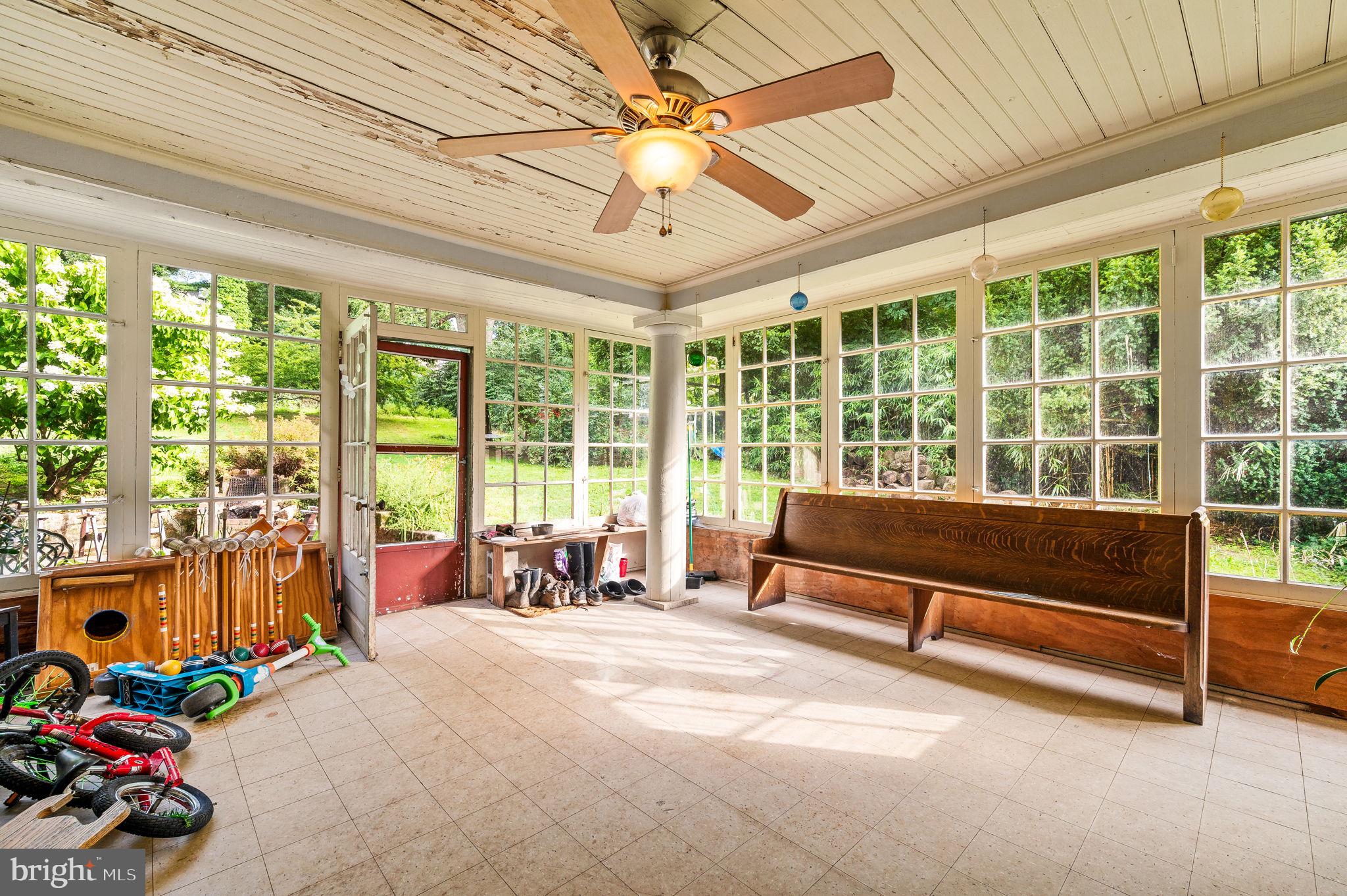 408 East Woodlawn Street Philadelphia, PA 19144 - Photo 13 of 31 a bedroom with furniture and large windows