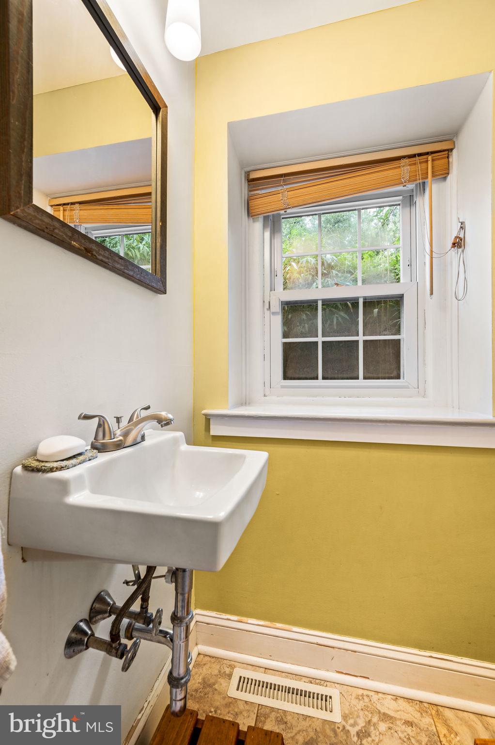 408 East Woodlawn Street Philadelphia, PA 19144 - Photo 14 of 31 a bathroom with a sink and a window