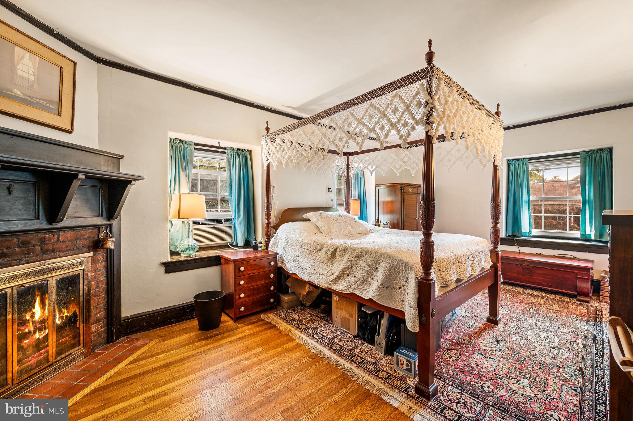 408 East Woodlawn Street Philadelphia, PA 19144 - Photo 16 of 31 a bed room with a bed and a fireplace