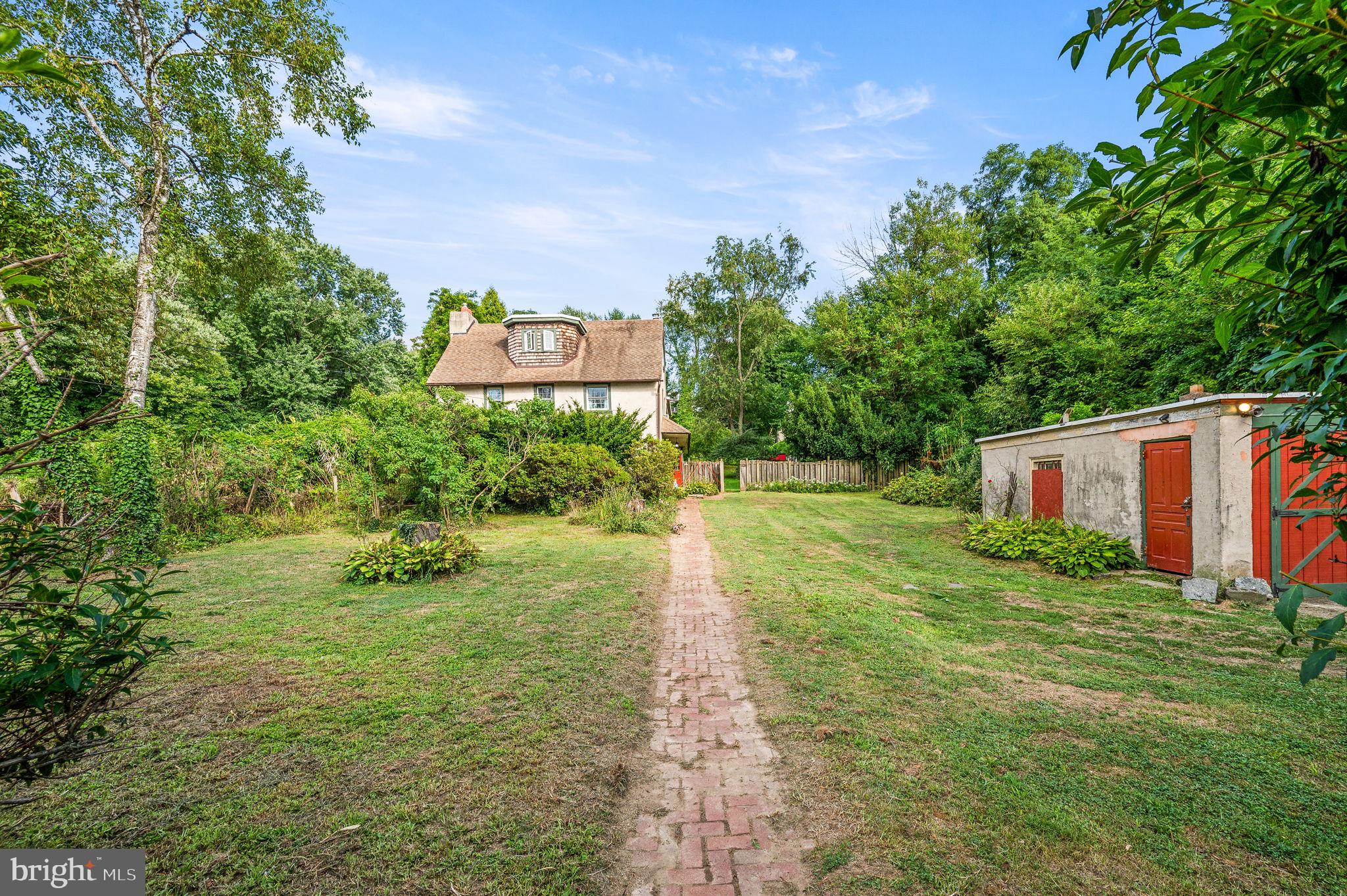 408 East Woodlawn Street Philadelphia, PA 19144 - Photo 2 of 31 a backyard of a house with a yard and outdoor seating