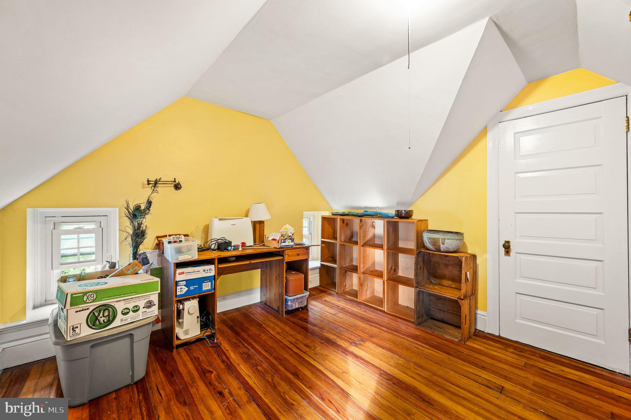 408 East Woodlawn Street Philadelphia, PA 19144 - Photo 23 of 31 a view of a bedroom with workspace and wooden floor