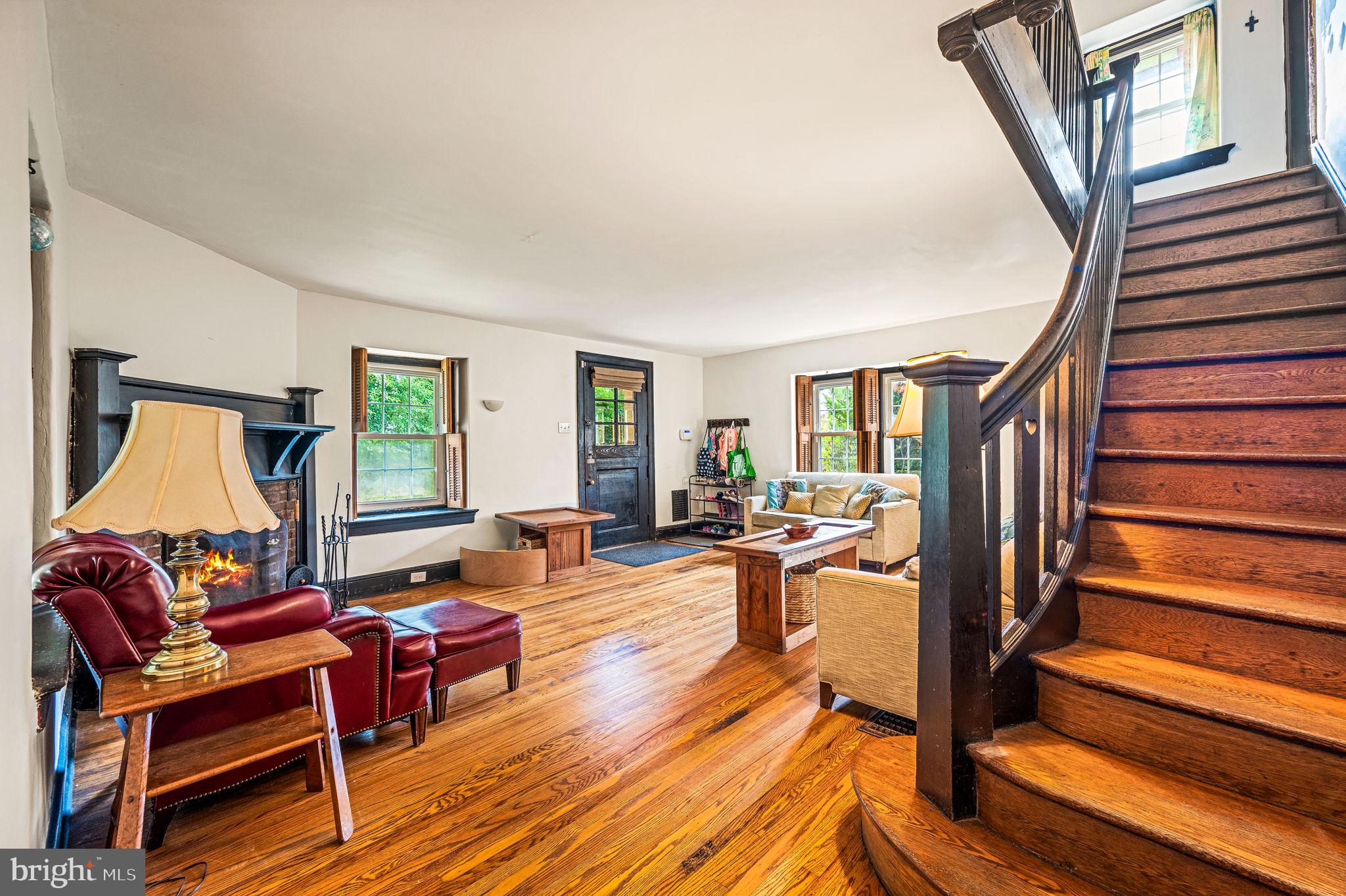 408 East Woodlawn Street Philadelphia, PA 19144 - Photo 4 of 31 a living room with furniture a fireplace and a wooden floor