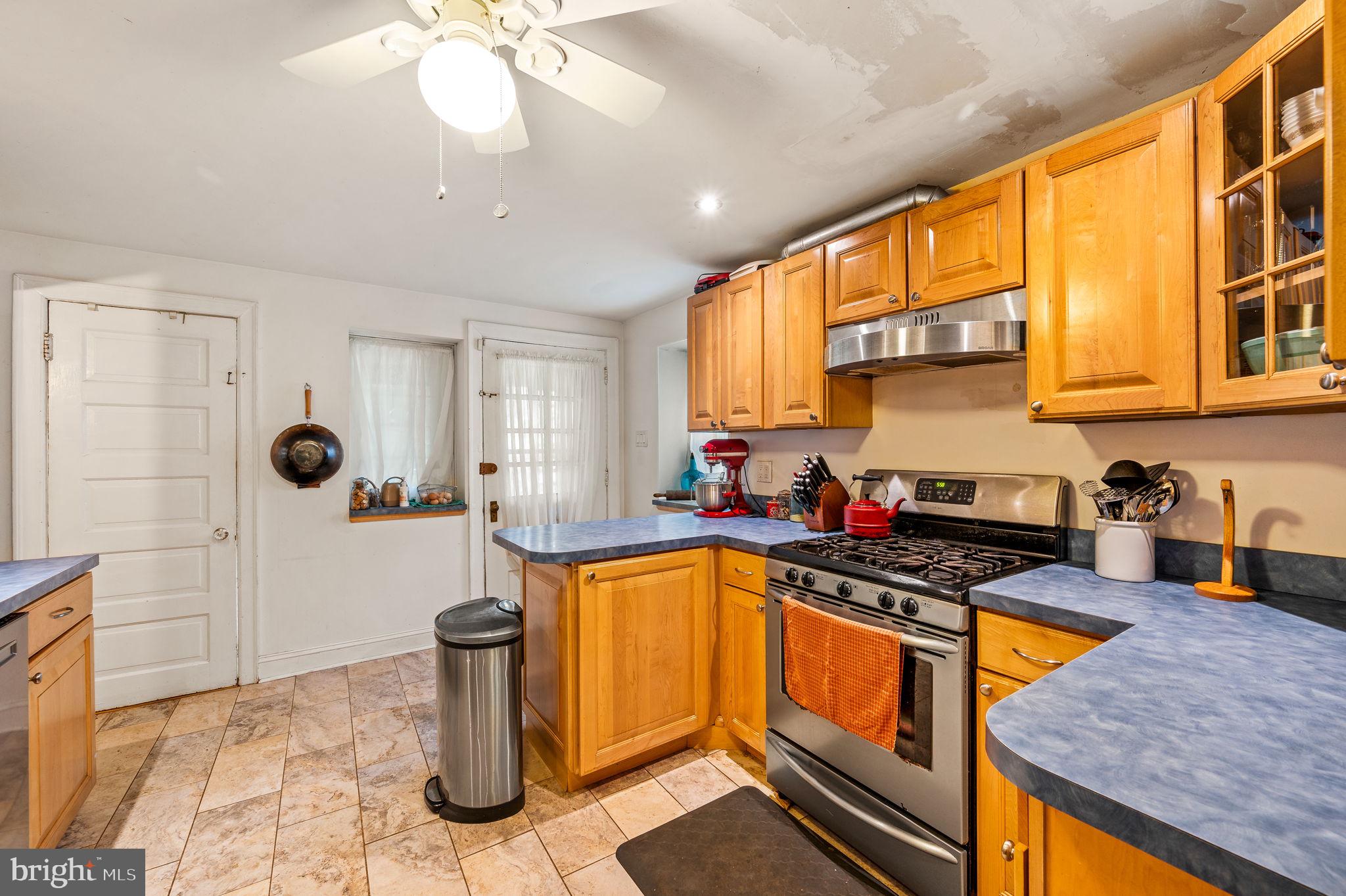 408 East Woodlawn Street Philadelphia, PA 19144 - Photo 10 of 31 a kitchen with stainless steel appliances granite countertop a stove a sink and a microwave