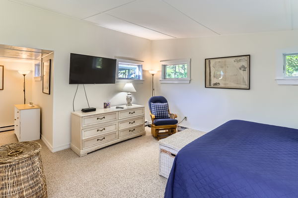 217 Barnes Road Oak Bluffs, MA 02557 - Photo 45 of 60 a bedroom with a bed and flat screen tv