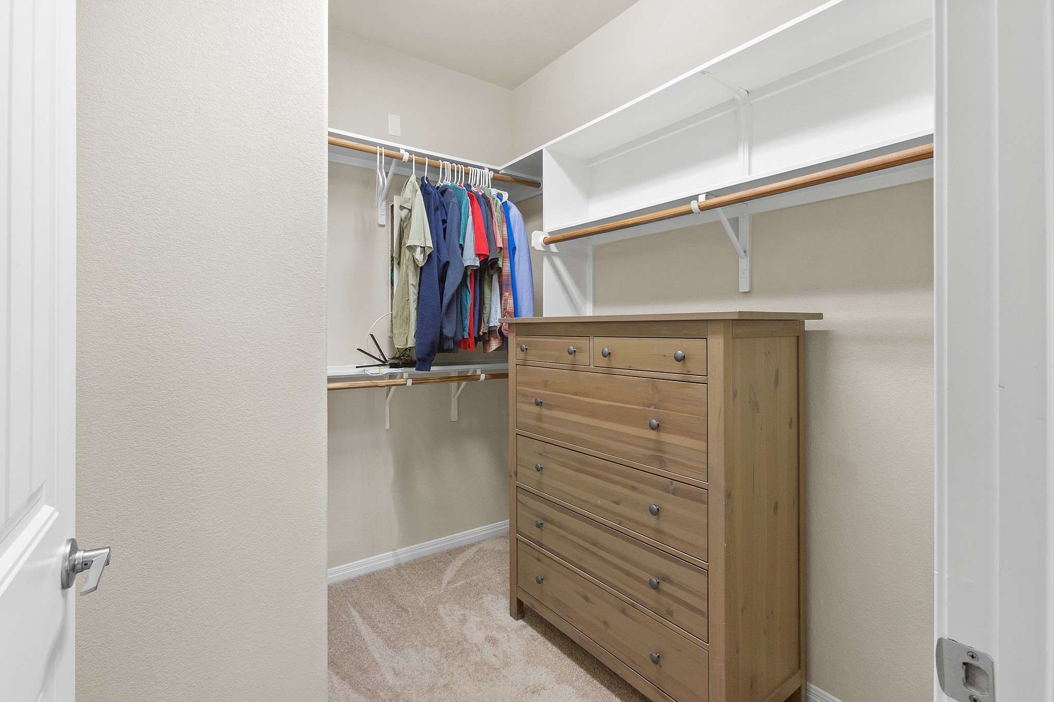 8916 Cattle Baron Path Austin, TX 78747 - Photo 19 of 37 a view of walk in closet with clothes