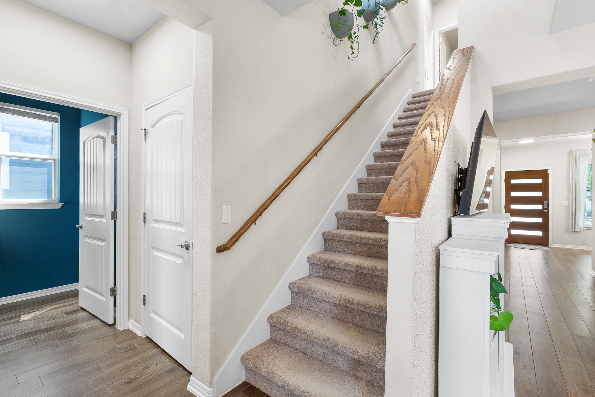 8916 Cattle Baron Path Austin, TX 78747 - Photo 21 of 37 a view of staircase with lots of frames on wall and wooden floor