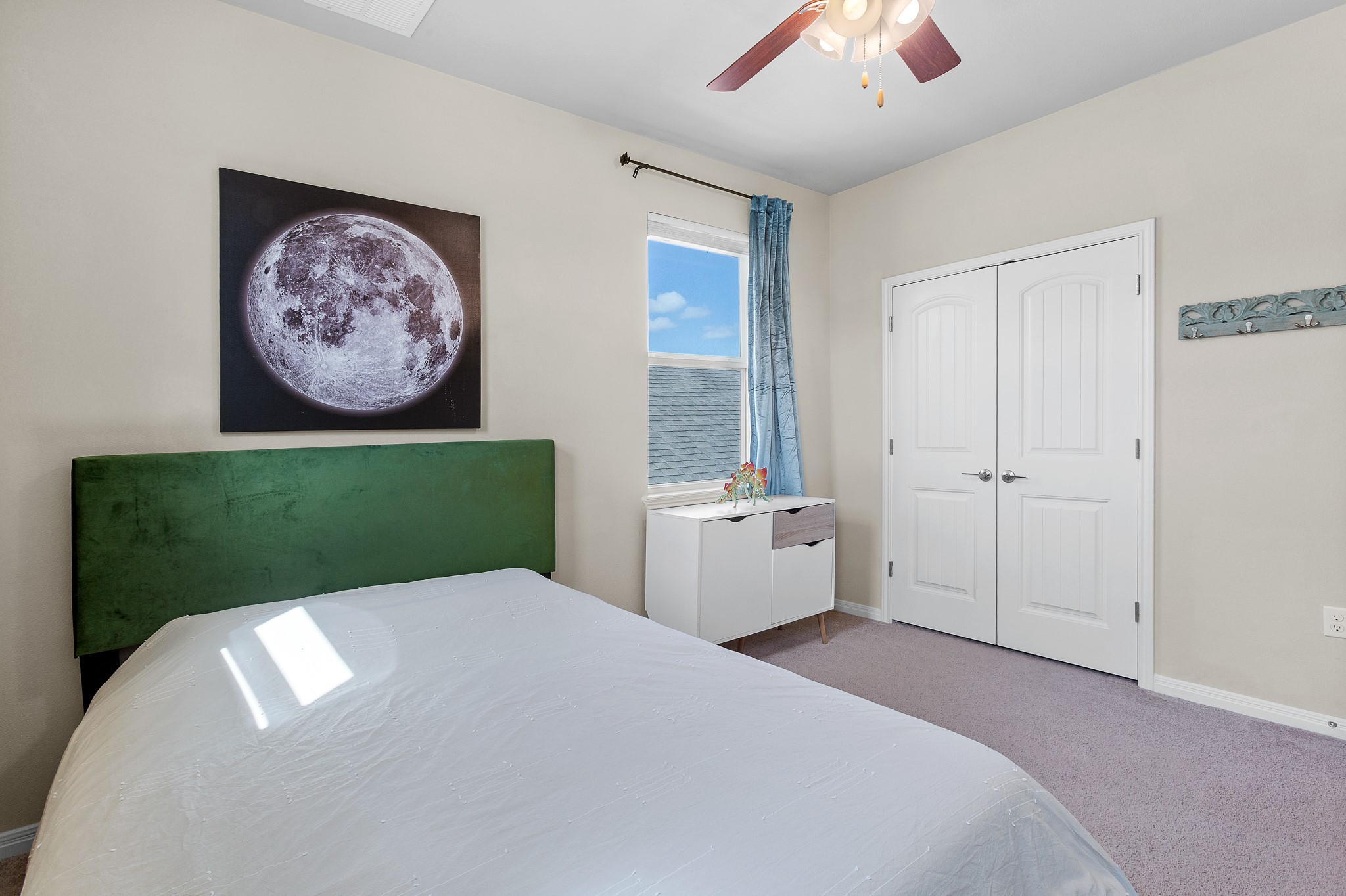 8916 Cattle Baron Path Austin, TX 78747 - Photo 25 of 37 a bedroom with a bed and a painting on the wall