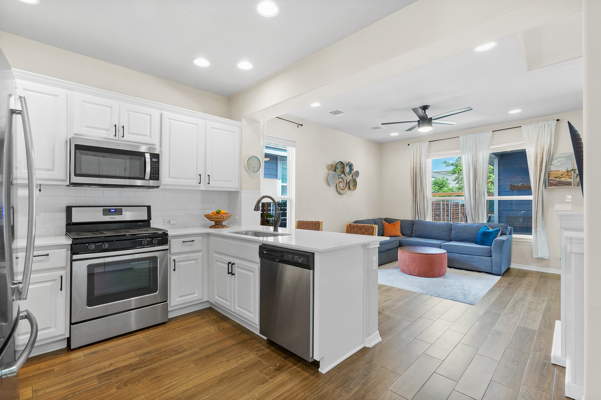 8916 Cattle Baron Path Austin, TX 78747 - Photo 8 of 37 a kitchen with a sink dishwasher stove and wooden cabinets