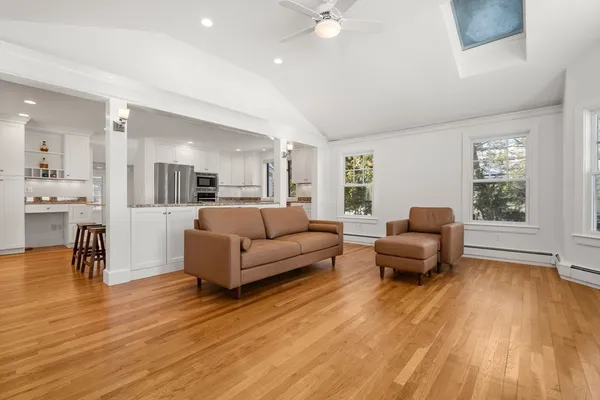 a living room with furniture and a wooden floor