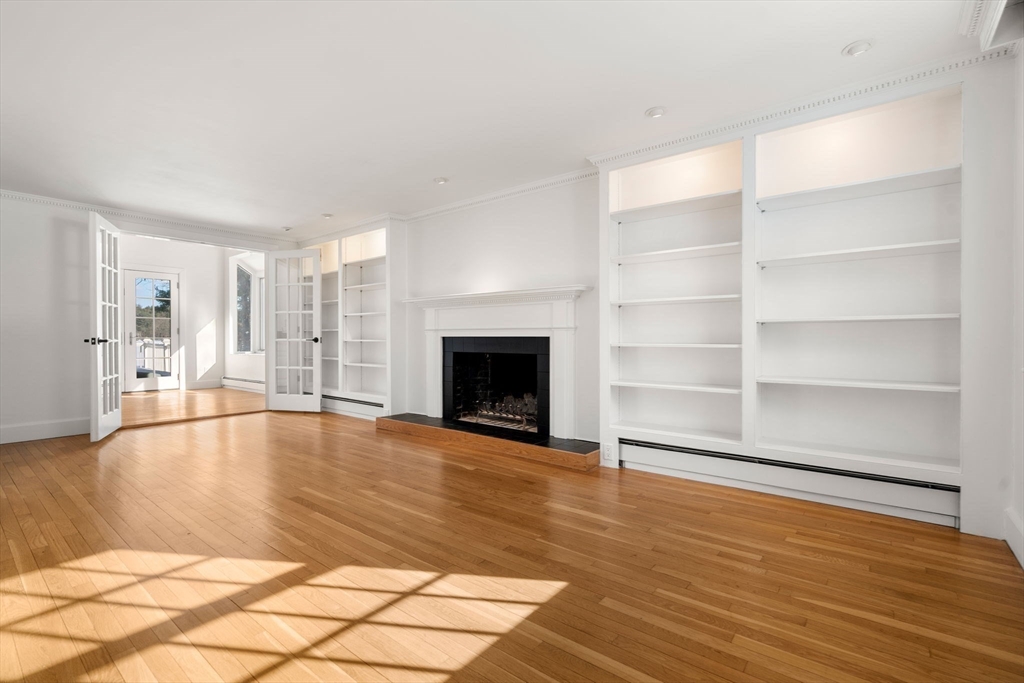 31 College Road Wellesley, MA 02482 - Photo 13 of 38 a view of empty room with wooden floor and fireplace