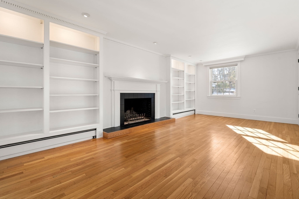 31 College Road Wellesley, MA 02482 - Photo 14 of 38 a view of empty room with wooden floor and fireplace