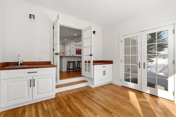 a open kitchen with cabinets and wooden floor