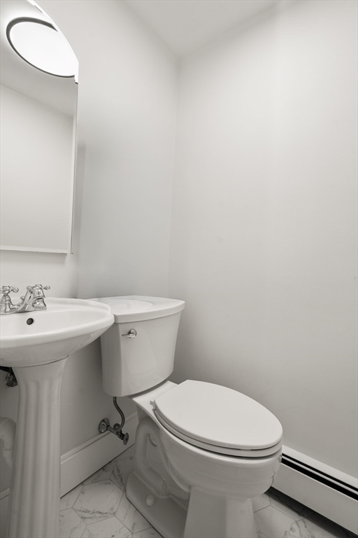 31 College Road Wellesley, MA 02482 - Photo 19 of 38 a white toilet sitting next to a bathroom sink