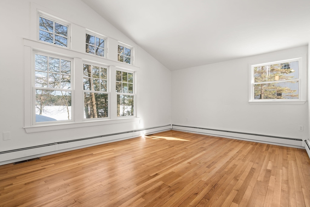 31 College Road Wellesley, MA 02482 - Photo 20 of 38 a view of an empty room with wooden floor and a window