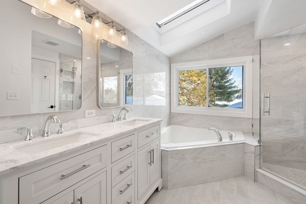 31 College Road Wellesley, MA 02482 - Photo 22 of 38 a bathroom with a granite countertop tub sink and mirror